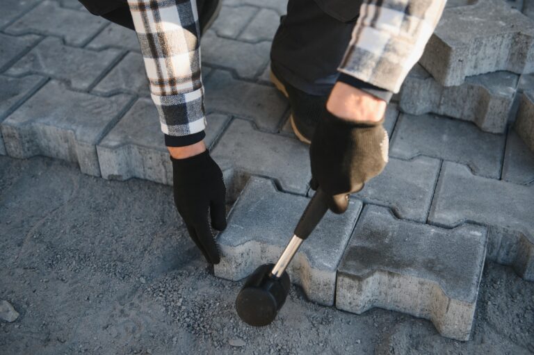 Close up of concrete bricks being installed on a patio in Tiverton